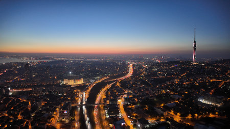 City skyline at sunset with lights and tall tower visible in istanbulの写真素材