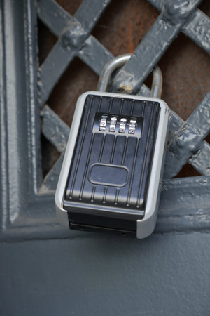 Combination lock secures access to a metal gateの写真素材