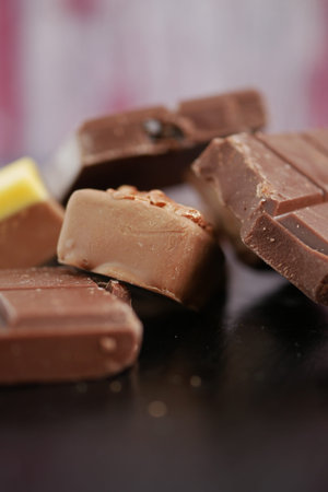 Chocolate pieces are scattered on a flat surface
