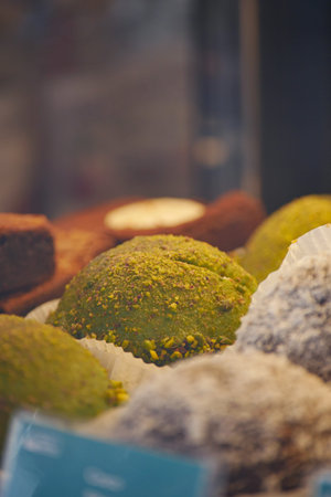 Green dessert with nuts and sweets at a bakery display