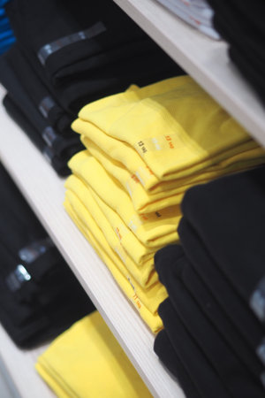 Clothes stacked on shelves in a retail store display