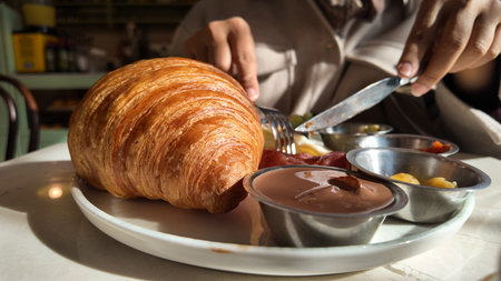 Croissant served with dipping sauces at a cafe tableの写真素材
