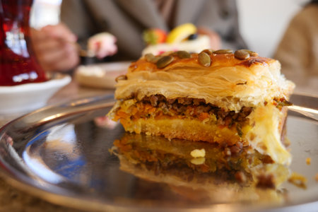 Pastry filled with meat and vegetables served on a trayの写真素材