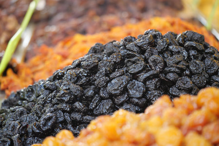 Close-Up Of Black Raisins In Colorful Dried Fruit Mix For Snack Or Cooking Useの写真素材