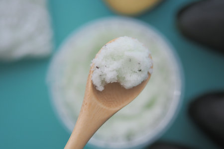 spoon hold avocado scrub closeupの写真素材