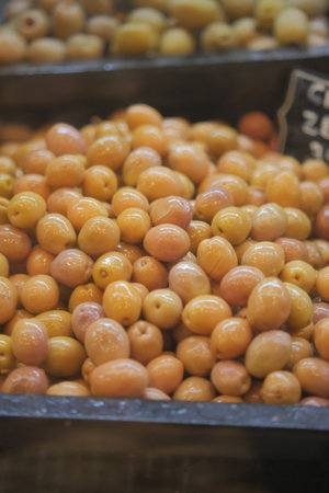 Fresh olives stacked at a market in late afternoon lightの写真素材