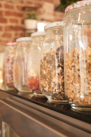 Jars filled with dry tea leaf display in a kitchenの写真素材