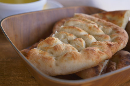 Fresh bread served in a wooden bowl for lunchの写真素材