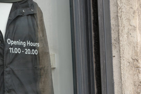 Store opening hours displayed on glass door