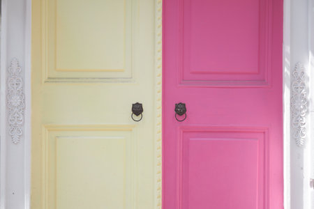 Two colorful doors in a bright setting with unique designsの写真素材