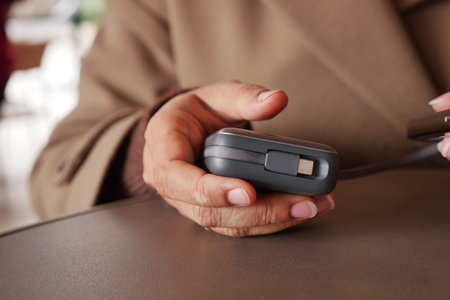 Person holds device in a cafe during the daytime