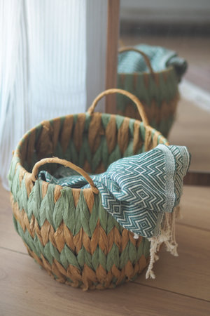 Woven basket with a cloth placed inside at home settingの写真素材