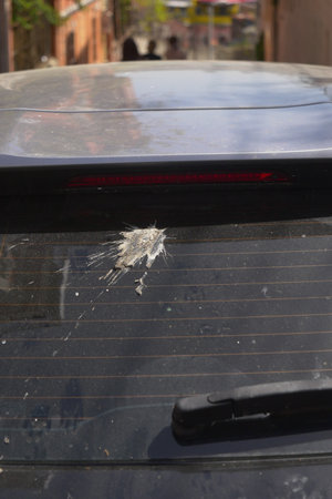 Damage on car rear window from bird droppingsの写真素材