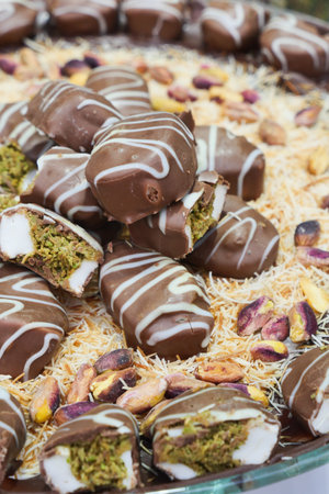 Delicious sweets with nuts and chocolate on a tray