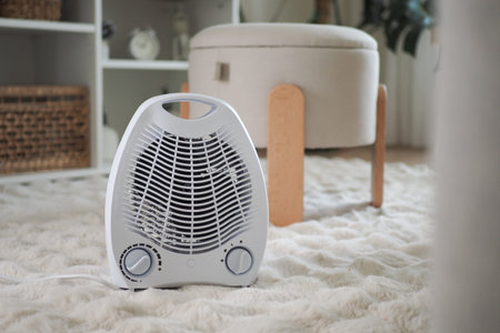 Small heater on a rug in a simple living roomの写真素材