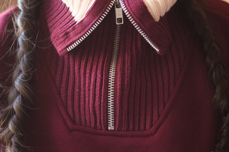 Girl wearing a sweater with a zip collar in sunlight