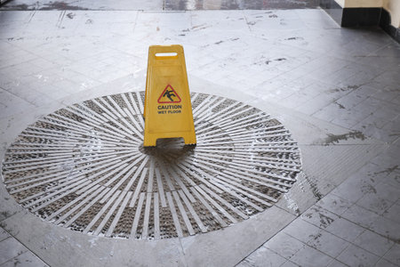 Caution sign on wet floor in a public building area
