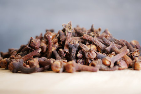 Dried cloves are displayed on a wooden surfaceの写真素材