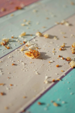 Crumbs scattered on a table after a meal in daylightの写真素材