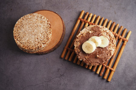 Oat cake with chocolate and banana on bamboo mat