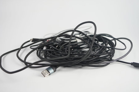 Cables are tangled on a plain background