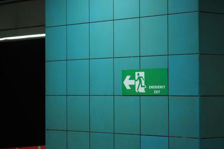 Emergency exit sign in subway station hallwayの写真素材