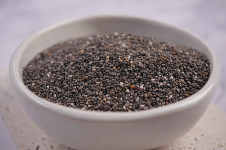 Chia seeds in a bowl on a light surfaceの写真素材