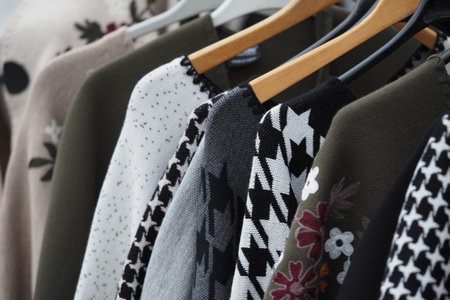 Different styles of sweaters on display during the dayの写真素材