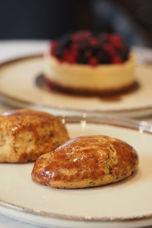 Scones and dessert on a table in a cafe setting