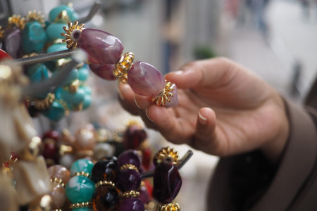 Person shops for jewelry at a market in the afternoonの写真素材