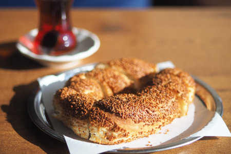 Fresh baked simit and tea on a wooden table