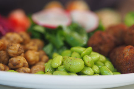 Salad bowl with chickpeas and greens on a table