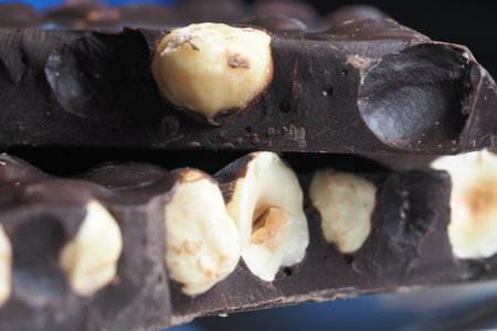 Chocolate bar with nuts on a dark background
