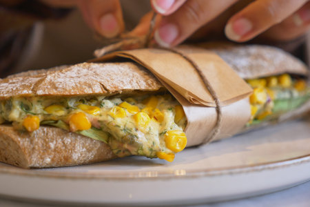 Delicious sandwich being prepared at a dining table