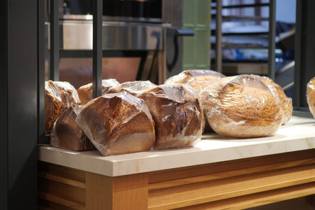 Fresh bread loaves on display at a bakery counter