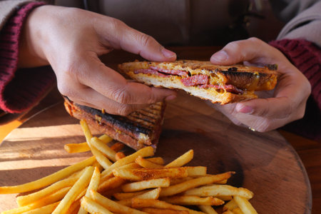 Enjoying a sandwich and fries at a cafe during lunch