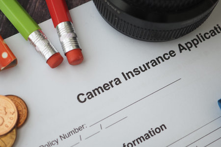 Camera insurance application on table with tools
