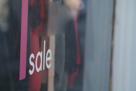 Shop display shows sale sign in storefront window