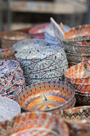 Colorful bowls stacked in a market display for sale
