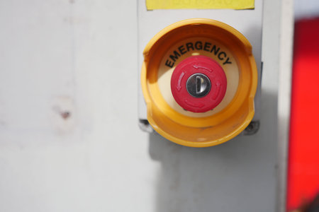 Emergency button on equipment in a workspace area