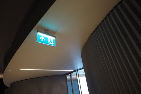 Exit sign pointing the way in a hallway