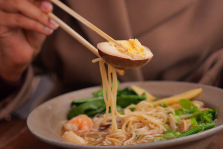 Enjoying a bowl of noodles with shrimp and vegetables