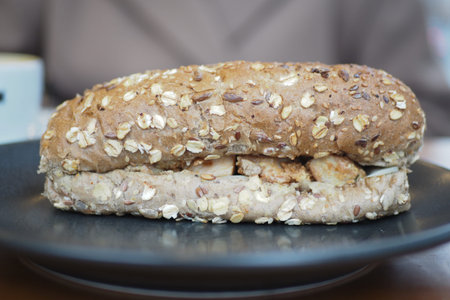 Fresh sandwich on a plate with healthy grains and filling