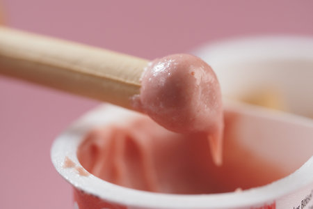 Creamy pink chocolate clings to a biscuits