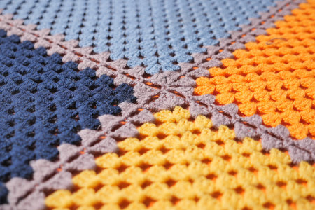 Colorful crochet blanket with a unique pattern on display