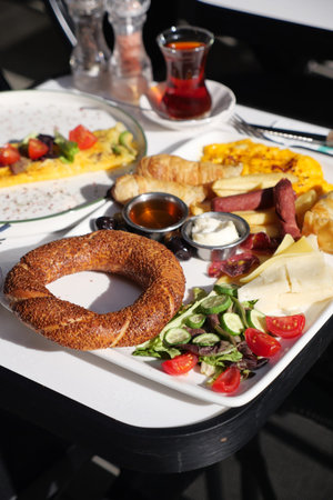 Turkish Breakfast spread with tea and different food items in a cafe