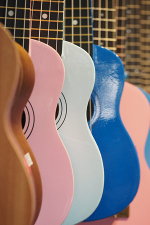 Colorful guitars hanging on a wall in a music shop