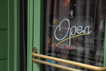 Sign shows open status at local business during day