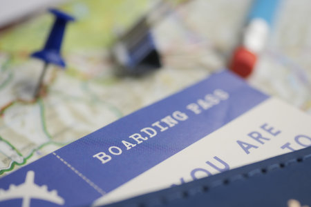 Planning a trip with a boarding pass and a map