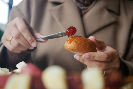 Eating bread with jam in a cozy cafe setting